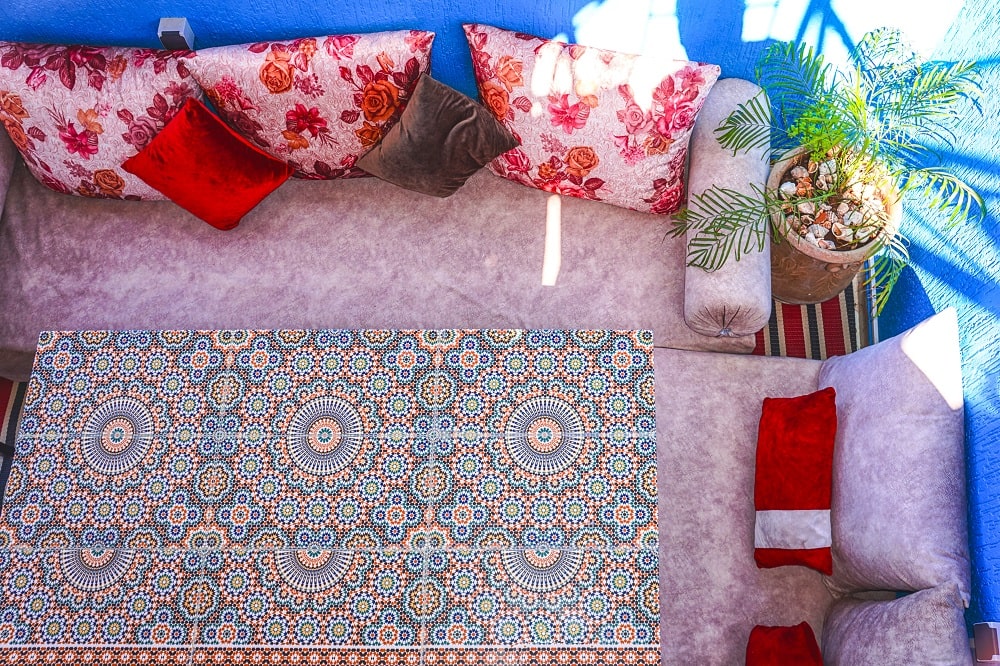 Zellige dining table with traditional Moroccan banquettes