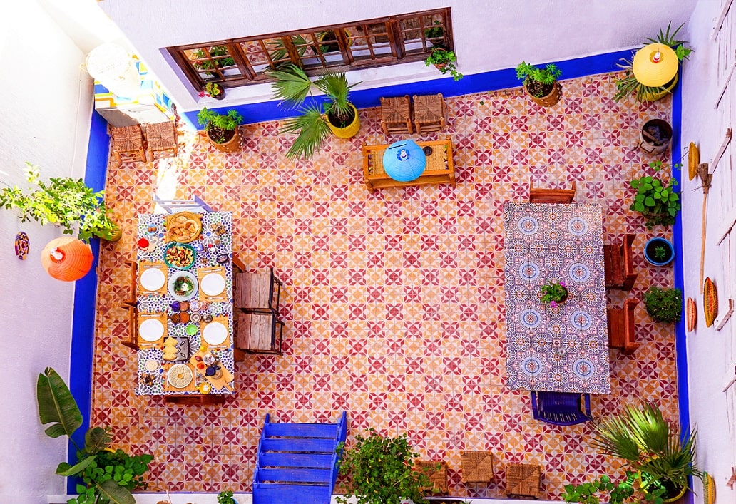Courtyard dining table laid for a shared meal in the riad