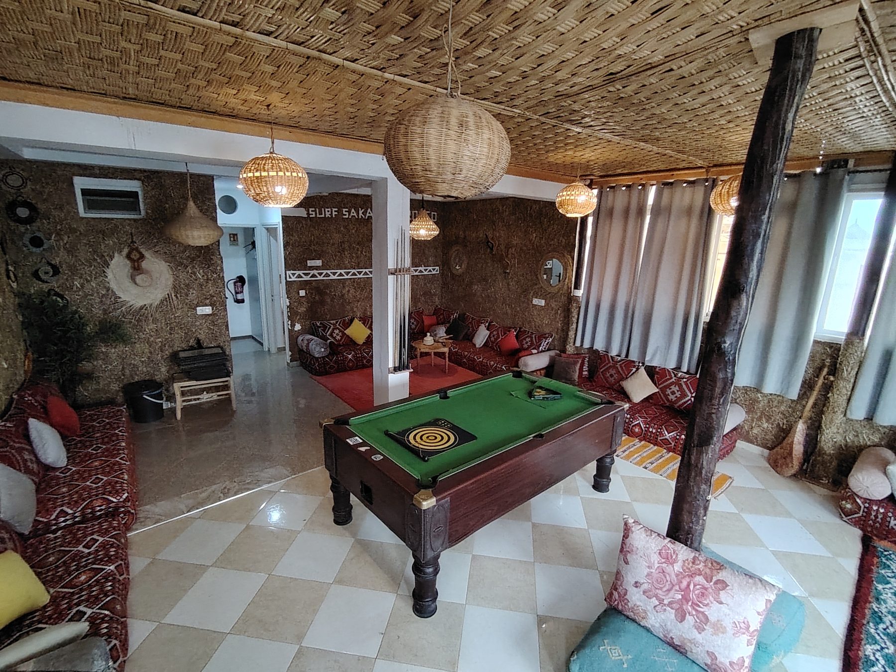 Berber lounge with low seating, rugs and a pool table